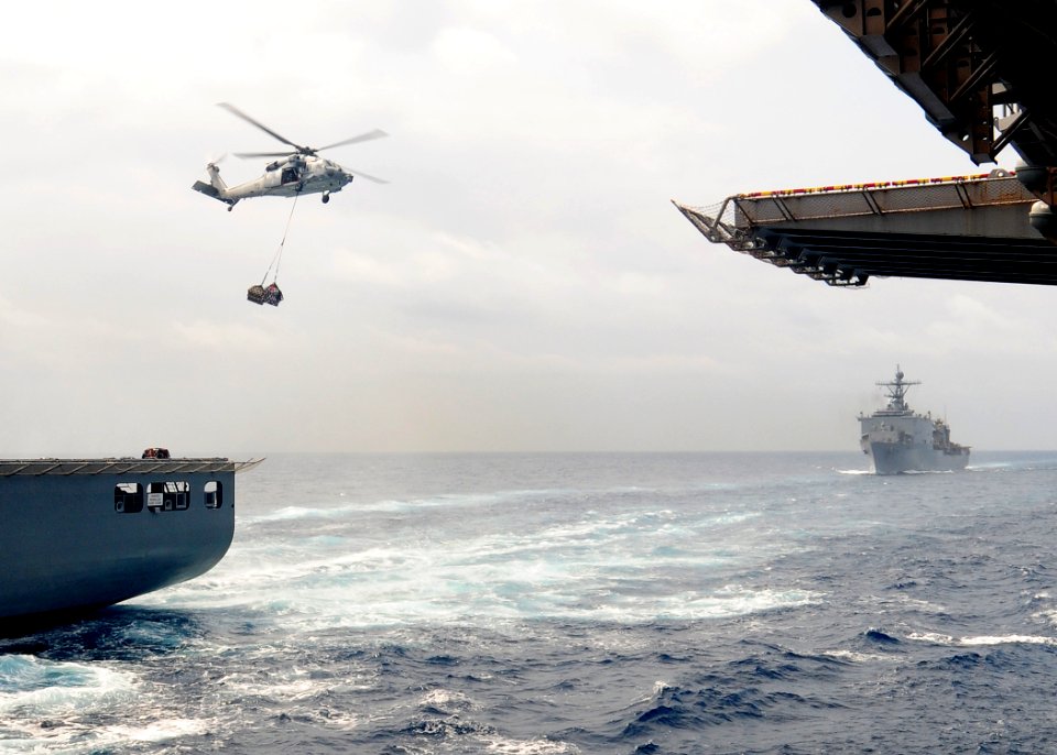 US Navy 110315-N-5538K-183 An MH-60S Sea Hawk helicopter transports humanitarian assistance supplies
