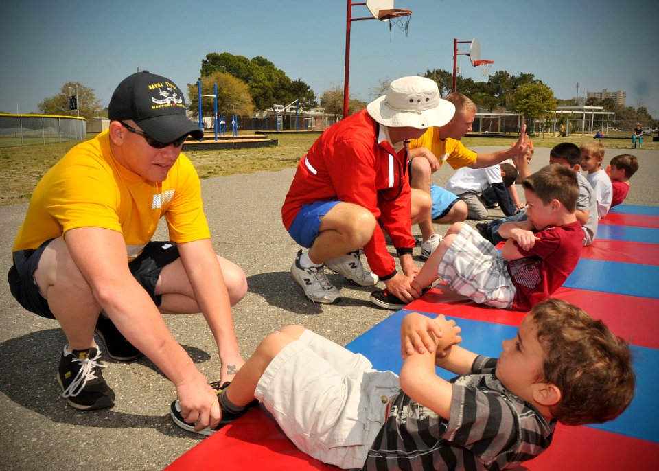 US Navy 110316-N-AW702-001 oatswain's Mate Seaman William Spellman, assigned to harbor operations at Naval Station Mayport, helps a Kindergarten st