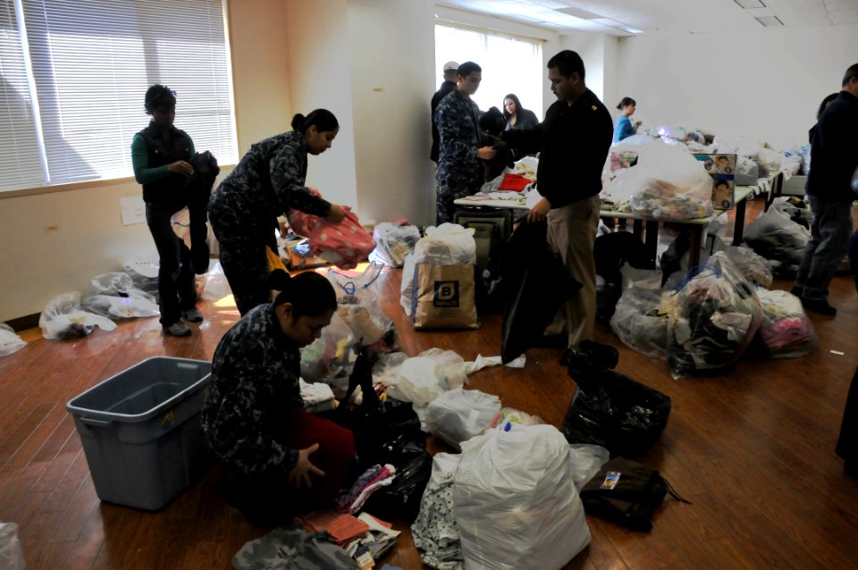 US Navy 110317-N-EA192-020 Sailors assigned to Commander, Fleet Activities Yokosuka sort humanitarian assistance supplies for distribution to Japan