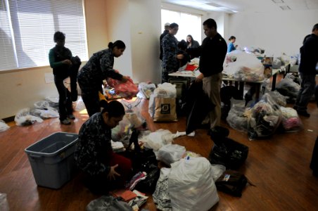US Navy 110317-N-EA192-020 Sailors assigned to Commander, Fleet Activities Yokosuka sort humanitarian assistance supplies for distribution to Japan