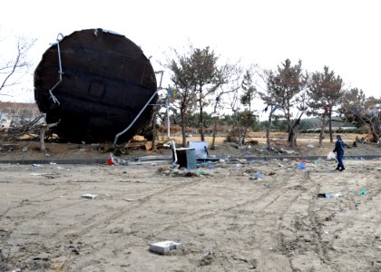 US Navy 110314-N-MU720-071 A Sailor assigned to Naval Air Facility Misawa picks up debris during a cleanup effort at the Misawa Fishing Port