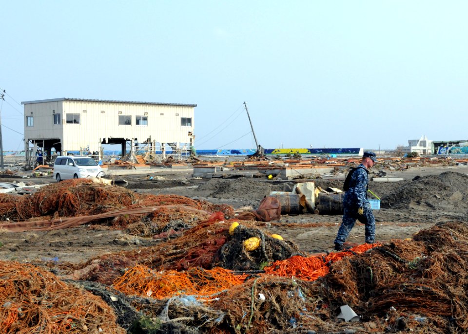 US Navy 110314-N-MU720-092 Mineman 2nd Class Cody Stone, from Phoenix, assigned to Naval Air Facility Misawa, walks through debris during a cleanup