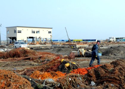 US Navy 110314-N-MU720-092 Mineman 2nd Class Cody Stone, from Phoenix, assigned to Naval Air Facility Misawa, walks through debris during a cleanup