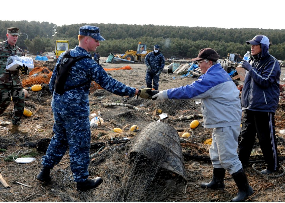 US Navy 110314-N-MU720-119 Mineman 2nd Class Cody Stone, from Phoenix, assigned to Naval Air Facility Misawa, recovers a spool of netting and retur