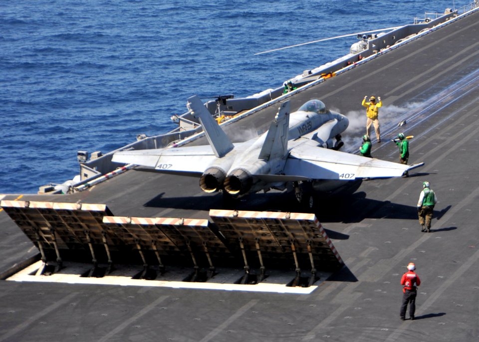 US Navy 110317-N-0569K-030 A shooter signals to the pilot of an F-A-18C Hornet assigned to the Thunderbolts of Marine Fighter Attack Squadron (VMFA