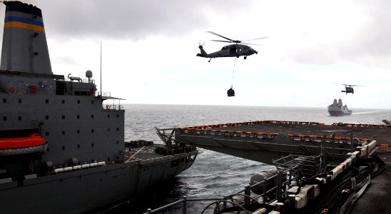 US Navy 110317-N-ZS026-031 MH-60 Sea Hawk helicopters assigned to the Wildcards of Helicopter Sea Combat Squadron (HSC) 23 transfer supplies from t