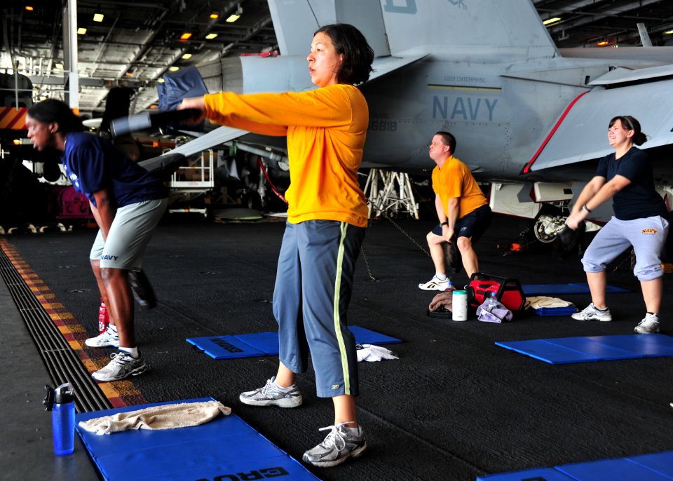 US Navy 110315-N-0074G-009 Sailors assigned to the aircraft carrier USS Enterprise (CVN 65) participate in a fitness class in the hangar bay