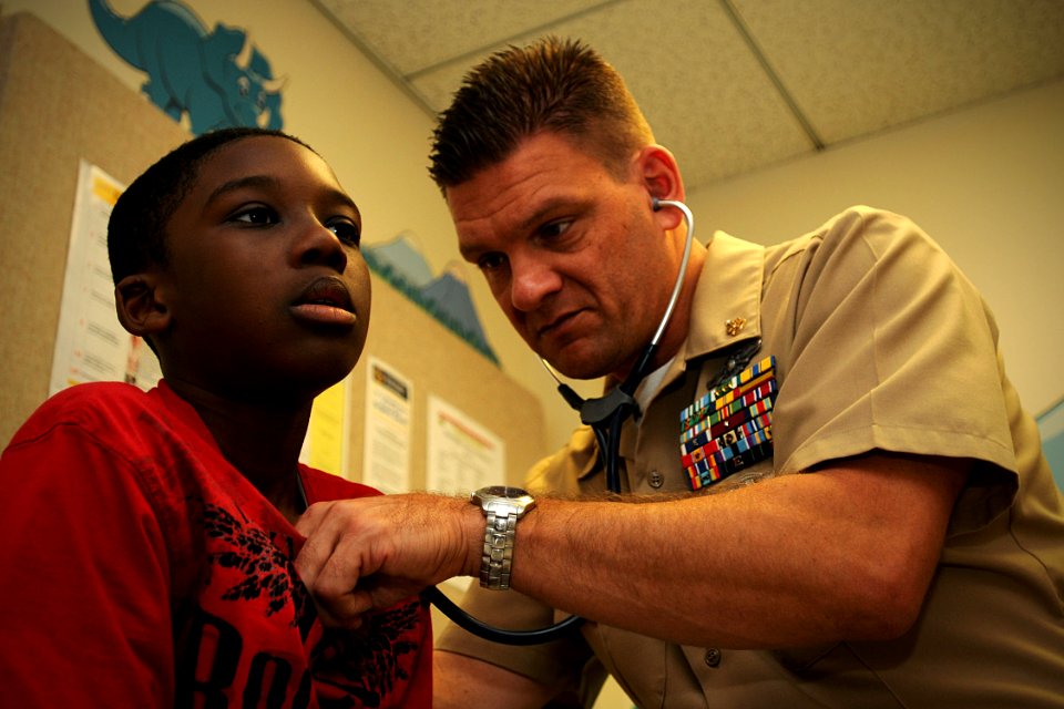 US Navy 110317-N-YR391-002 Senior Chief Hospital Corpsman Michael Holmes, assigned to Naval Hospital Jacksonville, examines a boy as part of an on