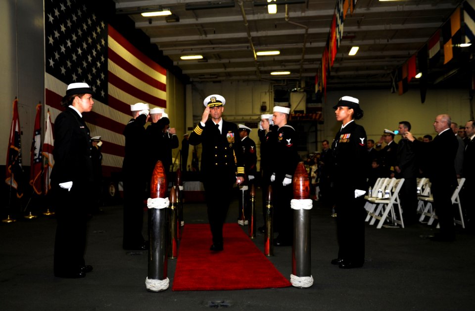 US Navy 110318-N-OY799-246 Sailors render honors to new commanding officer Capt. Ronald Reis at the completion of a change of command ceremony aboa