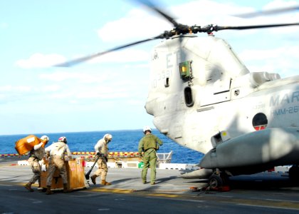 US Navy 110318-N-8607R-013 Marines assigned to the 31st Marine Expeditionary Unit (31st MEU) load humanitarian assistance supplies onto a CH-46E Se