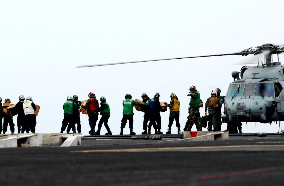 US Navy 110315-N-GL340-170 Sailors move food and water onto an HH-60H Sea Hawk helicopter assigned to the Black Knights of Anti-Submarine Squadron