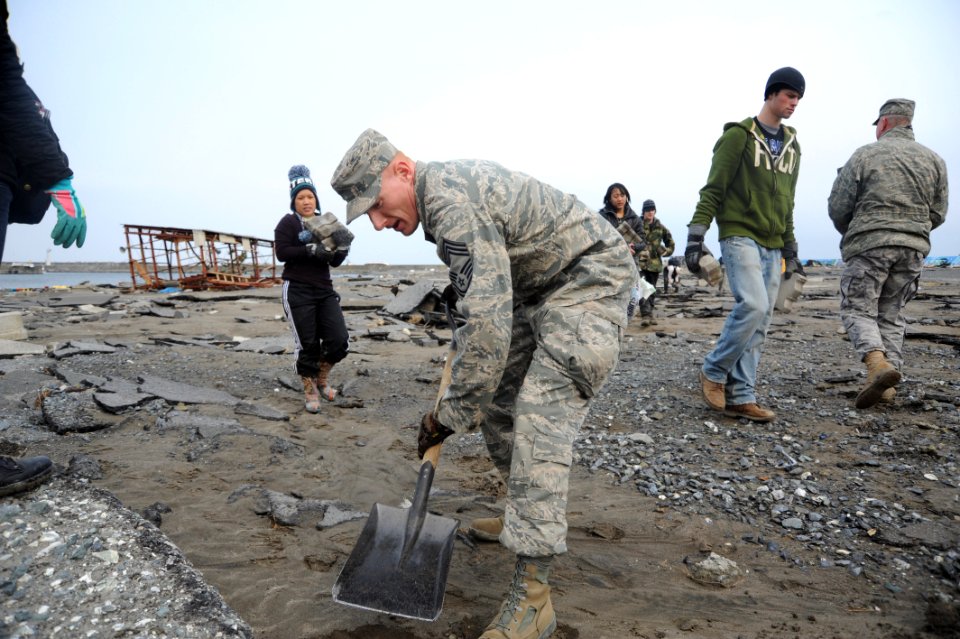 US Navy 110319-N-2653B-092 Chief Master Sgt. Matt Wickham, from Eldersburg Md., helps residents clear debris from the Misawa fishing port