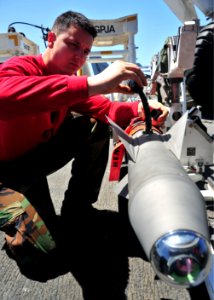 US Navy 110317-N-0074G-009 Aviation Ordnanceman Airman Luke Legaspi conducts a routine safety check on an aerial intercept missile aboard the aircr