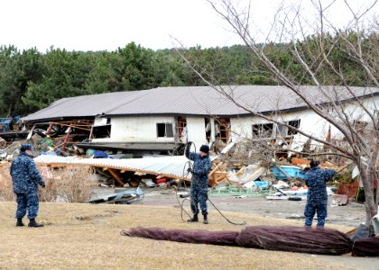 US Navy 110315-N-MU720-010 Sailors assigned to Naval Air Facility Misawa remove debris from a park at the Misawa Fishing Port