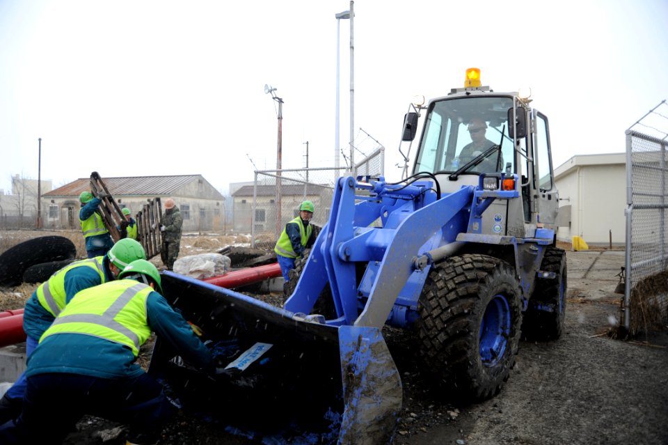 US Navy 110317-N-2653B-052 Sailors from the Japan Maritime Self-Defense Force load debris on a front loader driven by Equipment Operator 1st Class