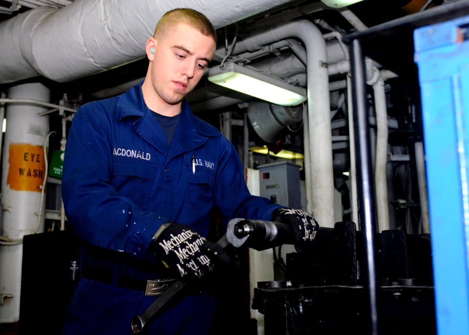 US Navy 110319-N-3154P-119 Machinist's Mate Fireman John Macdonald changes the tip of a burner barrel aboard USS Kearsarge (LHD 3)