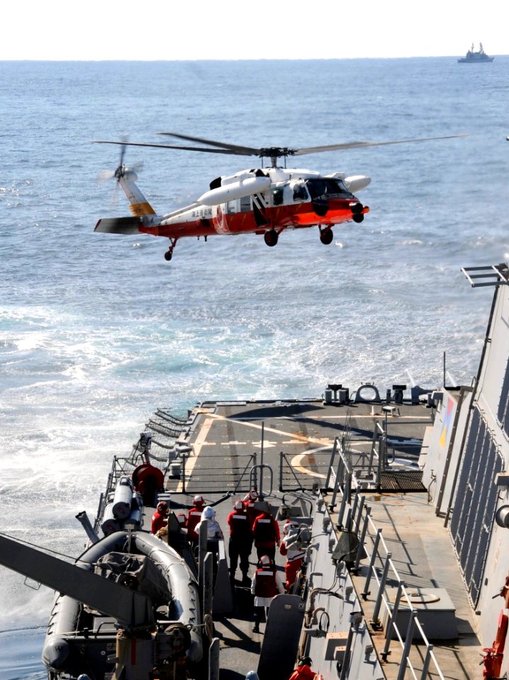 US Navy 110318-N-8288P-246 A Japan coast guard helicopter lands aboard the Arleigh Burke-class guided-missile destroyer USS Fitzgerald (DDG 62)