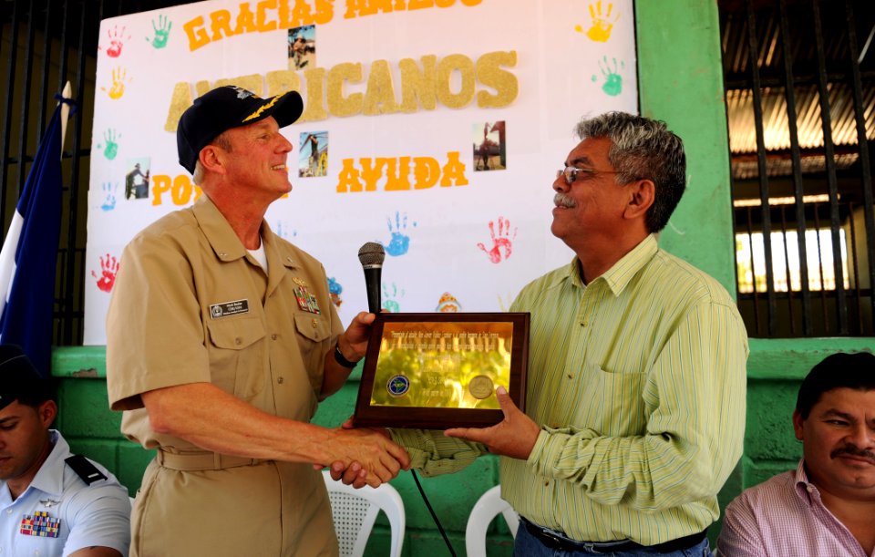 US Navy 110318-N-EC642-113 Cmdr. Mark Becker, left, presents a plaque to San Lorenzo Mayor Alex Javier Valdez Escobar during a closing ceremony at