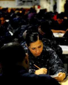 US Navy 110317-N-8040H-013 Ship's Serviceman Seaman Shanna Larios takes the E-4 advancement exam on the aft mess decks aboard the Nimitz-class air