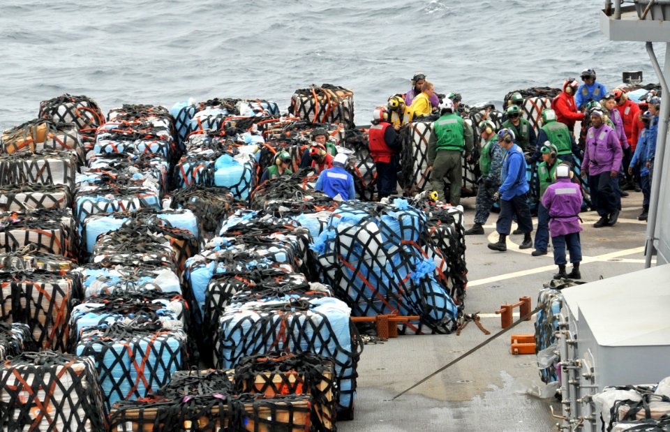 US Navy 110321-N-0864H-310 Sailors arrange pallets on the main deck aboard the U.S. 7th Fleet command ship USS Blue Ridge (LCC 19) during a vertica