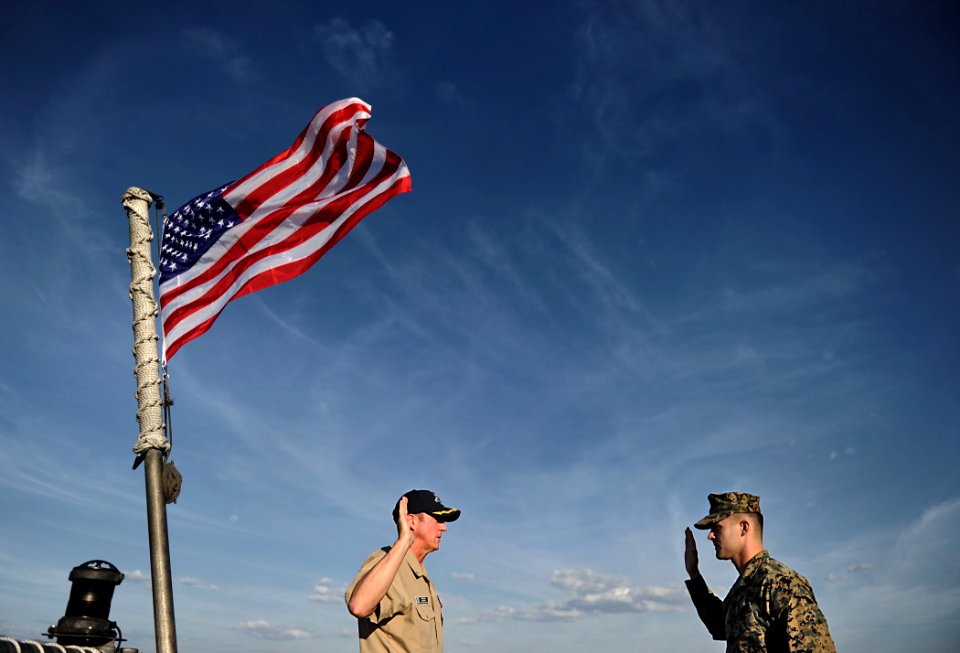 US Navy 110317-N-EC642-047 Cmdr. Mark Becker administers the oath of enlistment to Staff Sgt. Daniel Monteiro