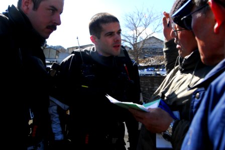 US Navy 110318-N-SB672-562 Sailors speak with Japanese men about providing additional supplies during a humanitarian assistance mission