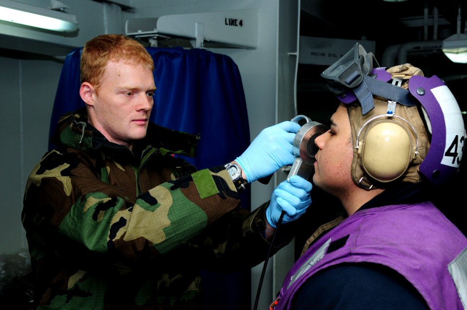 US Navy 110318-N-SG869-019 Engineman 1st Class Brandon Martin, left, uses an IM-271-PD Radiacmeter to detect possible surface contaminates on Aviat