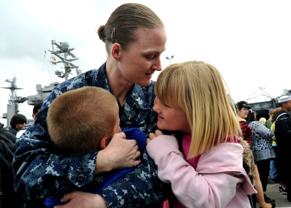US Navy 110319-N-YB753-170 Mass Communication Specialist 1st Class Sarah Murphy embraces her children upon return from a deployment aboard the airc