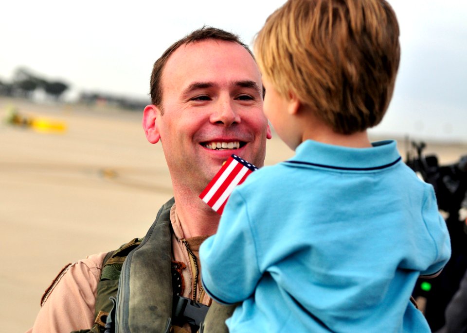 US Navy 110319-N-BT887-009 Lt. Cmdr. Jeff McGrady, a pilot assigned to Helicopter Sea Combat Squadron (HSC) 12, greets his son after a six-month de