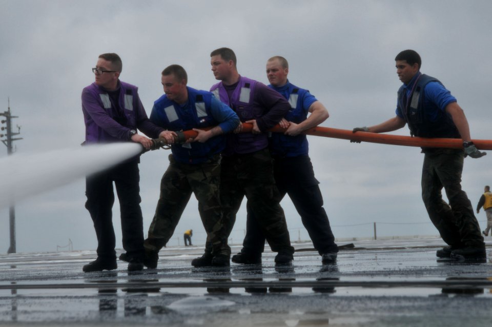 US Navy 110322-N-9643S-084 Sailors aboard the aircraft carrier USS George Washington (CVN 73) scrub the flight deck during a counter-measure wash d