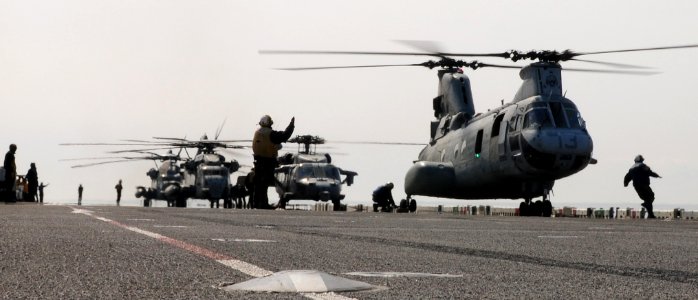 US Navy 110322-N-5538K-381 Sailors assigned to the forward-deployed amphibious assault ship USS Essex (LHD 2) prepare to launch helicopters loaded