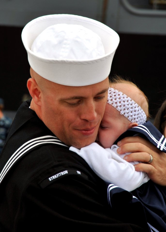 US Navy 110319-N-YB753-090 Aviation Structural Mechanic 1st Class Eric Anderson, assigned to Strike Fighter Squadron (VFA) 151, holds his newborn b