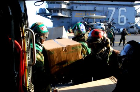 US Navy 110318-N-SB672-828 Sailors aboard the aircraft carrier USS Ronald Reagan (CVN 76) load humanitarian assistance supplies onto an HH-60H Sea