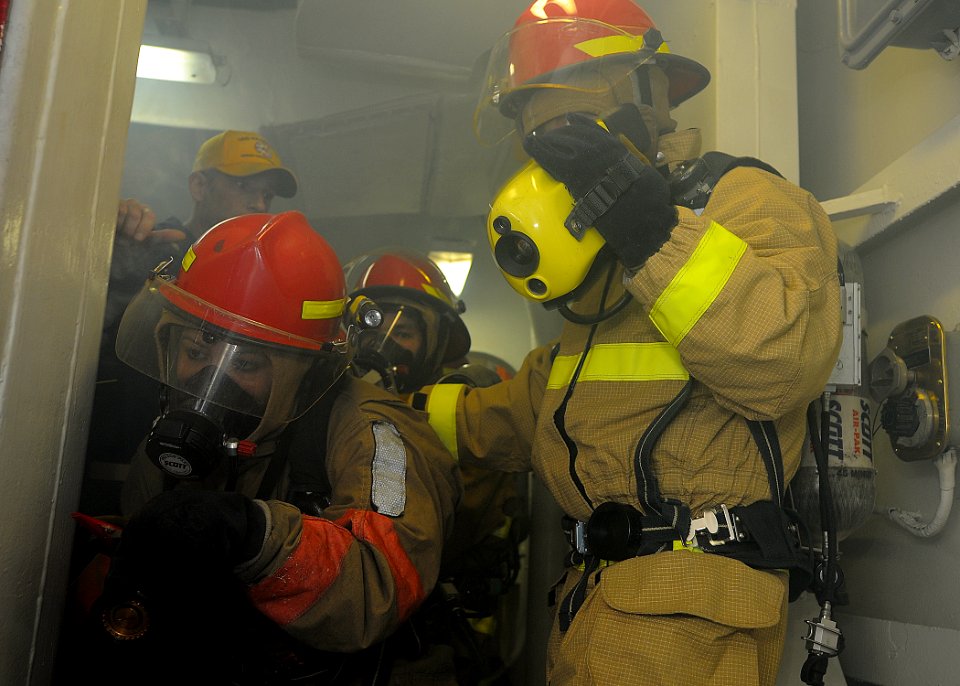 US Navy 110321-N-2908M-046 Fire party members engage a simulated fire aboard the amphibious assault ship USS Kearsarge (LHD 3)