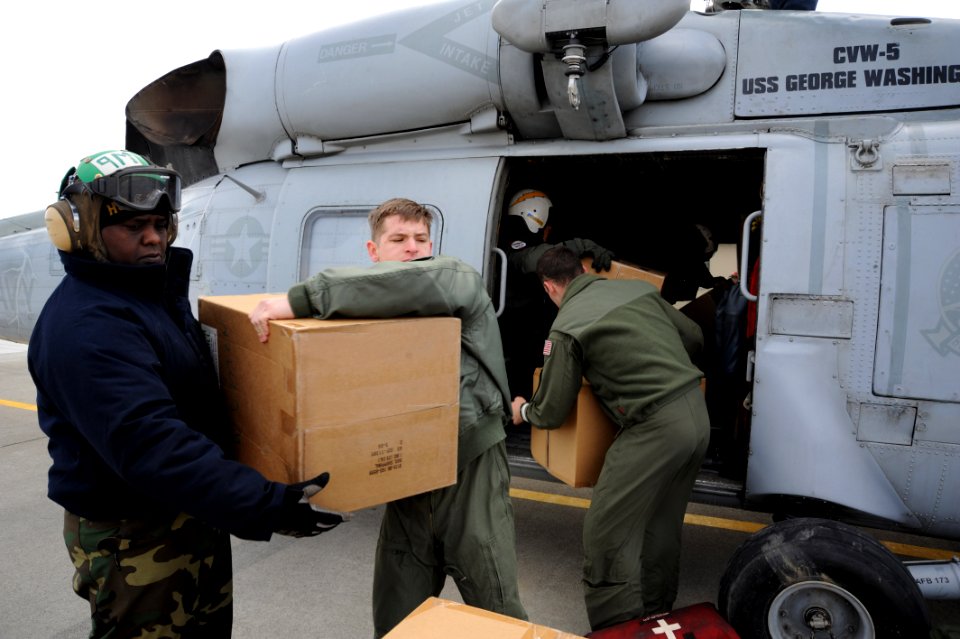 US Navy 110322-N-2653B-069 Aviation Structural Mechanic 2nd Class Andre Sparman, left, from Los Angeles, and Naval Air Crewman 3rd Class Matt Robin