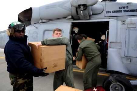 US Navy 110322-N-2653B-069 Aviation Structural Mechanic 2nd Class Andre Sparman, left, from Los Angeles, and Naval Air Crewman 3rd Class Matt Robin