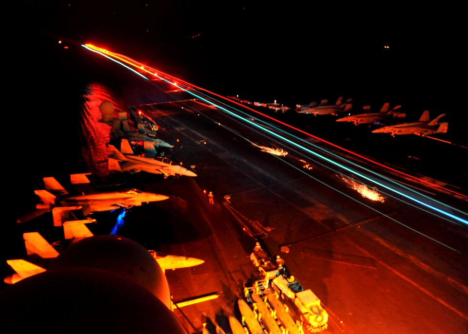 US Navy 110321-N-0569K-014 An F-A-18F Super Hornet lands aboard the aircraft carrier USS Enterprise (CVN 65) while conducting cyclic flight operati