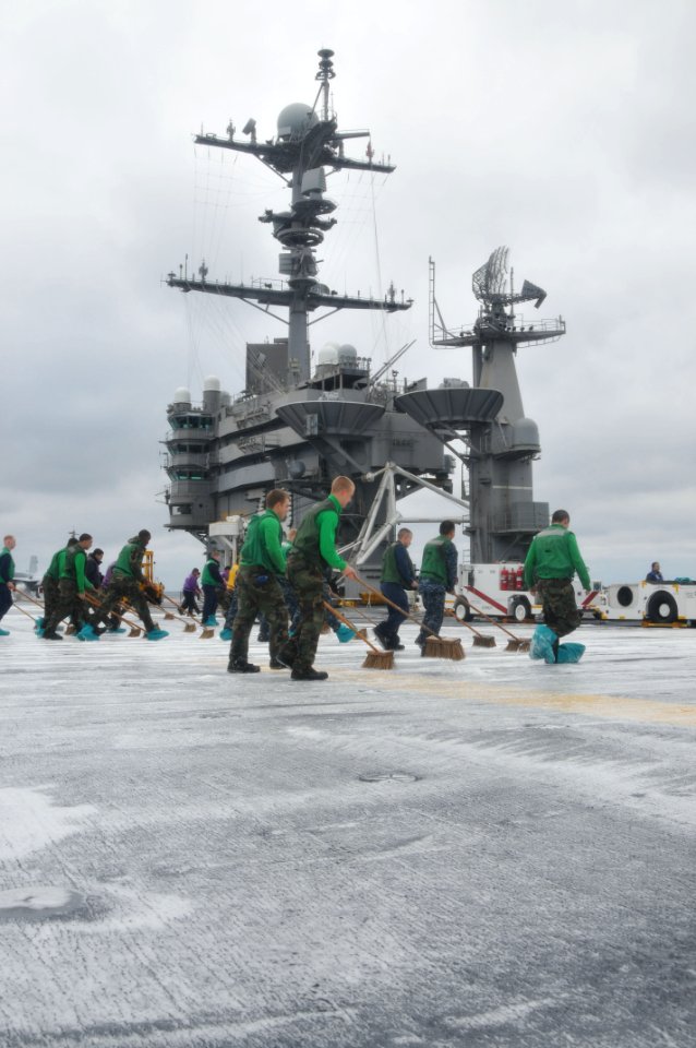 US Navy 110322-N-9643S-073 Sailors aboard the aircraft carrier USS George Washington (CVN 73) scrub the flight deck during a counter-measure wash d