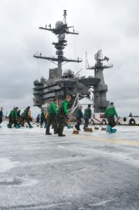 US Navy 110322-N-9643S-073 Sailors aboard the aircraft carrier USS George Washington (CVN 73) scrub the flight deck during a counter-measure wash d