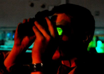 US Navy 110319-N-3154P-261 Naval Air Crewman 2nd Class Jordan Lochmann, assigned to Helicopter Sea Combat Squadron (HSC) 22, uses night vision bino photo
