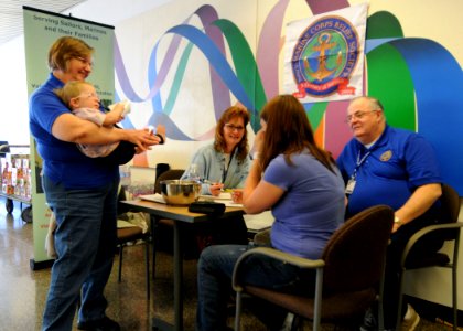 US Navy 110323-N-AE328-005 Mary Kay Gombos, director of the Naval Base Kitsap Navy and Marine Corps Relief Society, helps a military spouse with a
