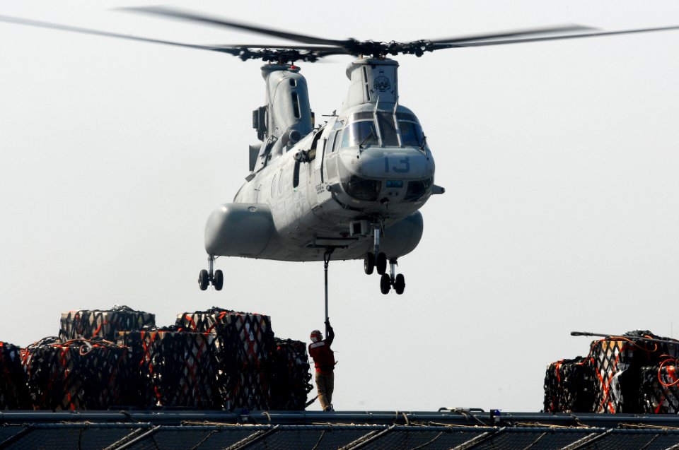US Navy 110322-N-SF508-093 A crew member of the Military Sealift Command dry cargo and ammunition ship USNS Matthew Perry (T-AKE 9) attaches cargo