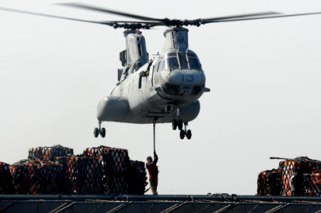 US Navy 110322-N-SF508-093 A crew member of the Military Sealift Command dry cargo and ammunition ship USNS Matthew Perry (T-AKE 9) attaches cargo
