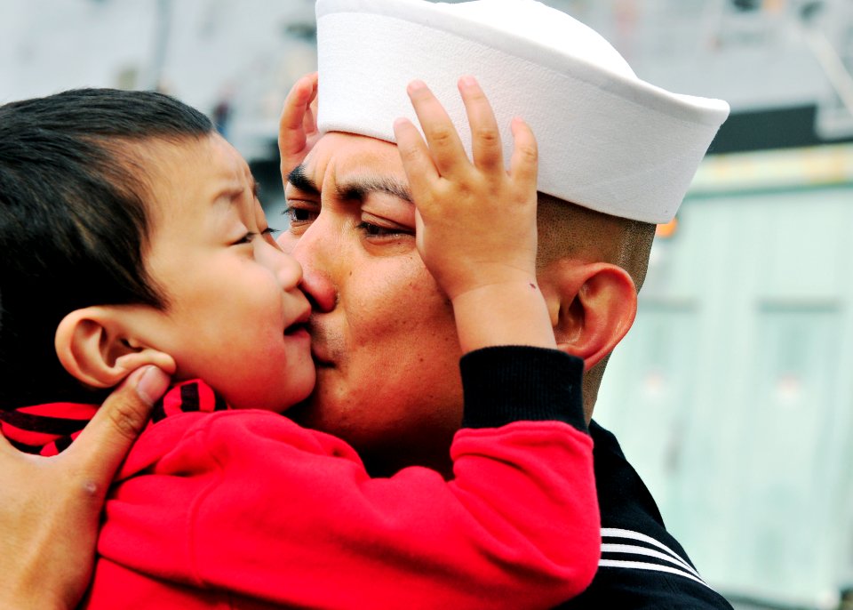 US Navy 110321-N-BT887-100 Hospital Corpsman 2nd Class Neil Palpallatoc embraces his son before deploying aboard the amphibious transport dock ship