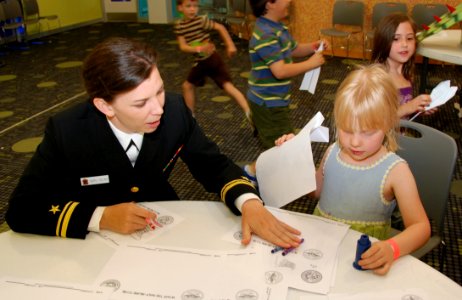 US Navy 110323-N-8750E-117 Lt. J.g. Cheryl Collins, assigned to Navy Community Outreach, helps a child color at the Mississippi Children's Museum d