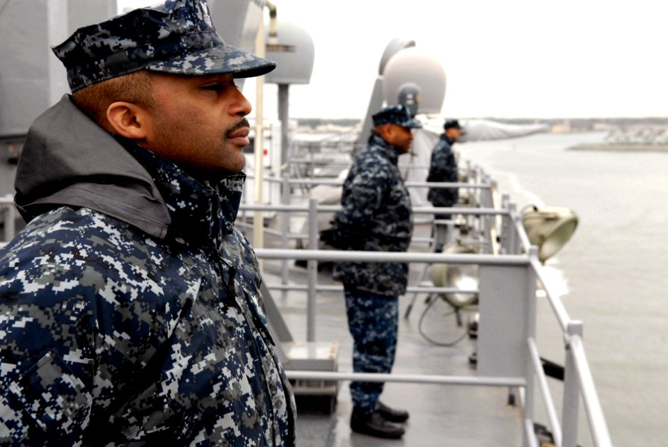 US Navy 110323-N-QP268-071 Sailors assigned to the amphibious dock landing ship USS Whidbey Island (LSD 41) man the rails as the ship departs Joint
