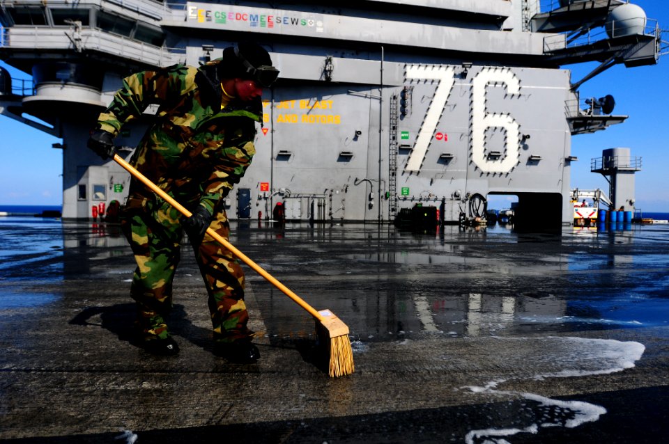 US Navy 110323-N-UO379-222 Aviation Boatswain's Mate (Handling) 3rd Class Ashton Hemphill scrubs the flight deck of the aircraft carrier USS Ronald