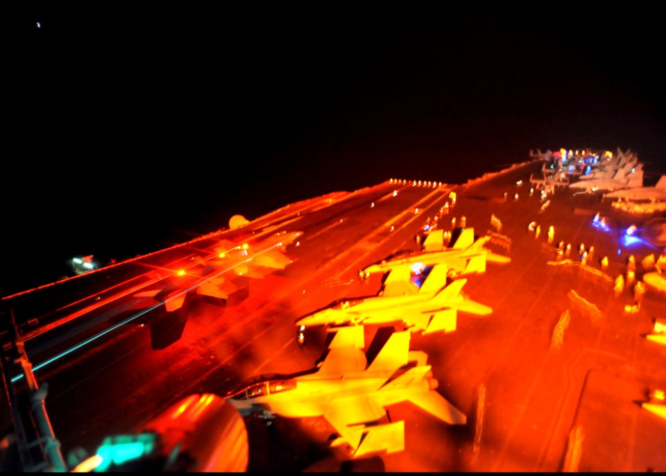 US Navy 110321-N-0569K-024 An F-A-18F Super Hornet lands aboard the aircraft carrier USS Enterprise (CVN 65) while conducting cyclic flight operati