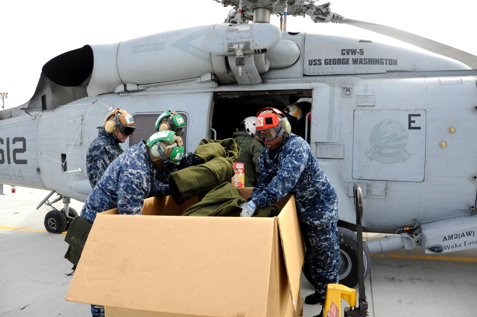 US Navy 110321-N-2653B-153 Sailors aboard the aircraft carrier USS Ronald Reagan (CVN 76) load supplies onto an SH-60F Sea Hawk helicopter from the