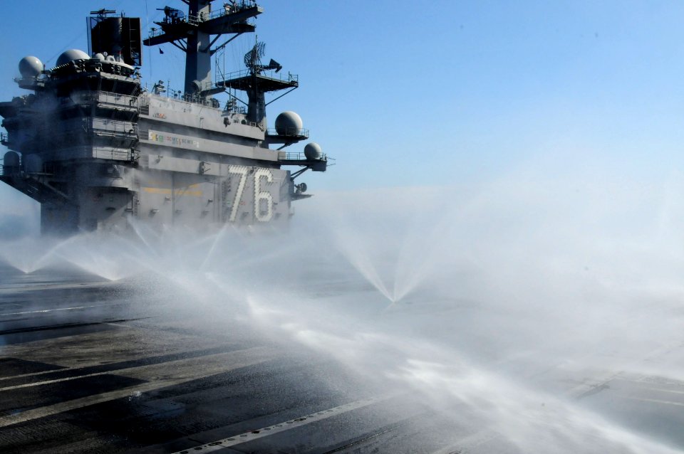 US Navy 110323-N-NB544-120 The aircraft carrier USS Ronald Reagan (CVN 76) conducts a countermeasure wash down to decontaminate the flight deck whi